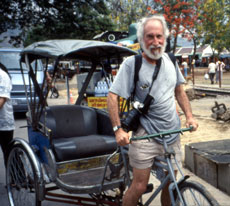 Soaking wet California Native founder, Lee Klein, pedals his rickshaw back into the melee of Songkran's Water Festival.